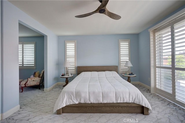 bedroom with ceiling fan, carpet flooring, baseboards, and multiple windows