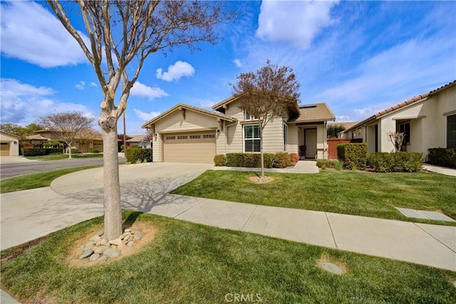 view of front of home featuring concrete driveway, a front yard, and a garage