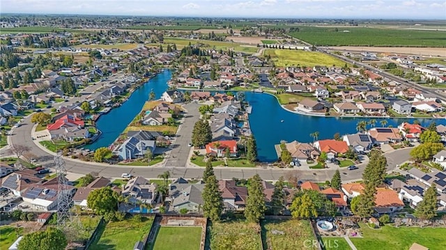 drone / aerial view with a residential view and a water view