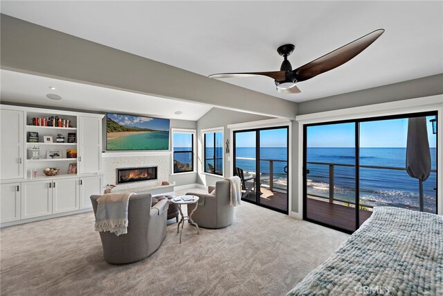 1001 Buena Vis Unit 2, San Clemente, CA 92672 - carpeted living room featuring vaulted ceiling, plenty of natural light, a ceiling fan, and a glass covered fireplace