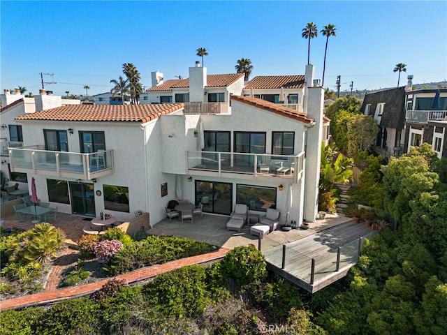 1001 Buena Vis Unit 2, San Clemente, CA 92672 - back of property with a tiled roof, stucco siding, a chimney, and a balcony