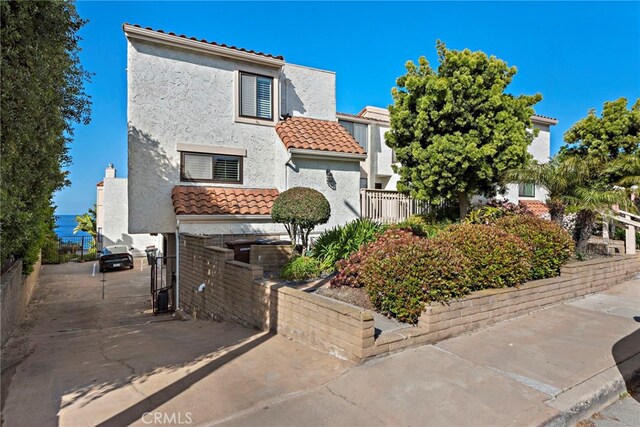 1001 Buena Vis Unit 2, San Clemente, CA 92672 - view of front of house with stucco siding, a tile roof, and fence