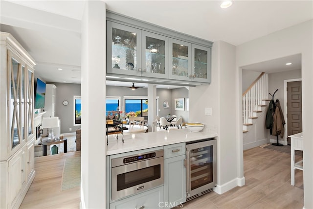 1001 Buena Vis Unit 2, San Clemente, CA 92672 - bar with light wood-type flooring, stairway, baseboards, wine cooler, and recessed lighting