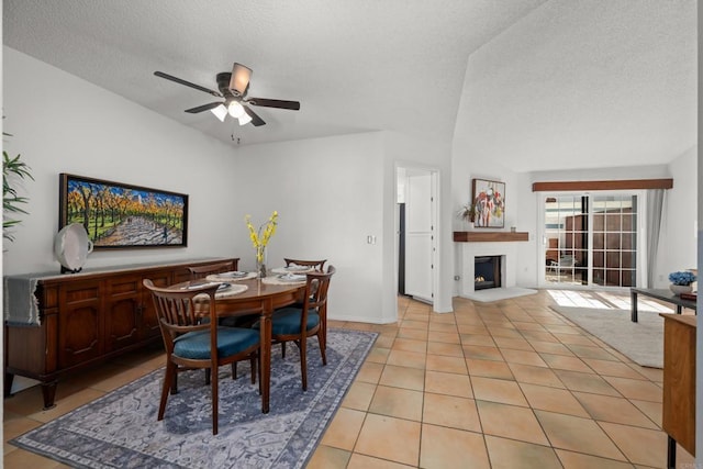 1579 Apache Dr Unit E, Chula Vista, CA 91910 - dining space featuring light tile patterned flooring, a ceiling fan, a textured ceiling, and a fireplace with raised hearth