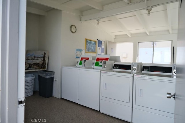 community laundry room featuring washing machine and clothes dryer and carpet
