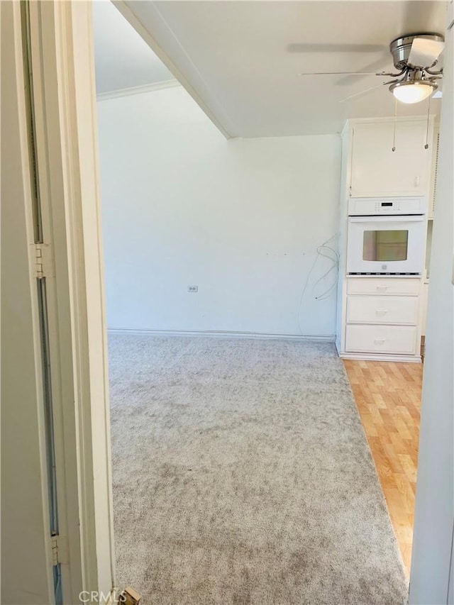 unfurnished living room with ceiling fan