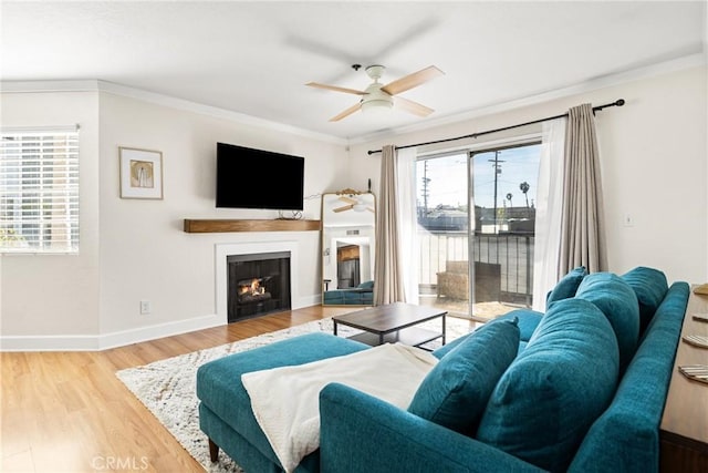 1100 Euclid Ave Unit 103, Long Beach, CA 90804 - living room featuring ceiling fan, ornamental molding, a lit fireplace, wood finished floors, and baseboards