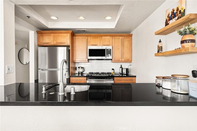 1100 Euclid Ave Unit 103, Long Beach, CA 90804 - kitchen featuring appliances with stainless steel finishes, a raised ceiling, backsplash, dark countertops, and recessed lighting