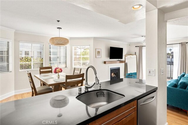 1100 Euclid Ave Unit 103, Long Beach, CA 90804 - kitchen with a sink, open floor plan, ornamental molding, dishwasher, and light wood-style floors