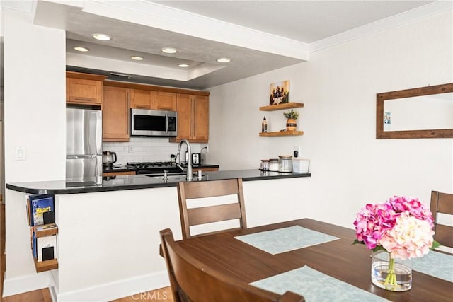 1100 Euclid Ave Unit 103, Long Beach, CA 90804 - kitchen featuring stainless steel appliances, backsplash, dark countertops, wood finished floors, and open shelves