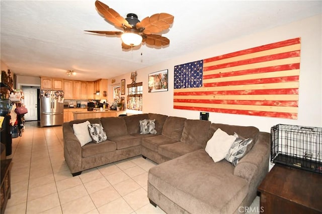living area with light tile patterned floors and a ceiling fan