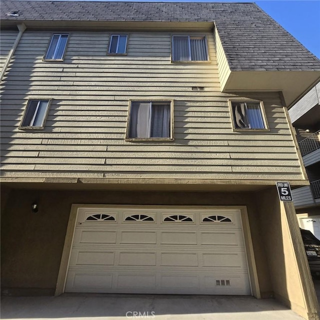 view of side of property featuring an attached garage