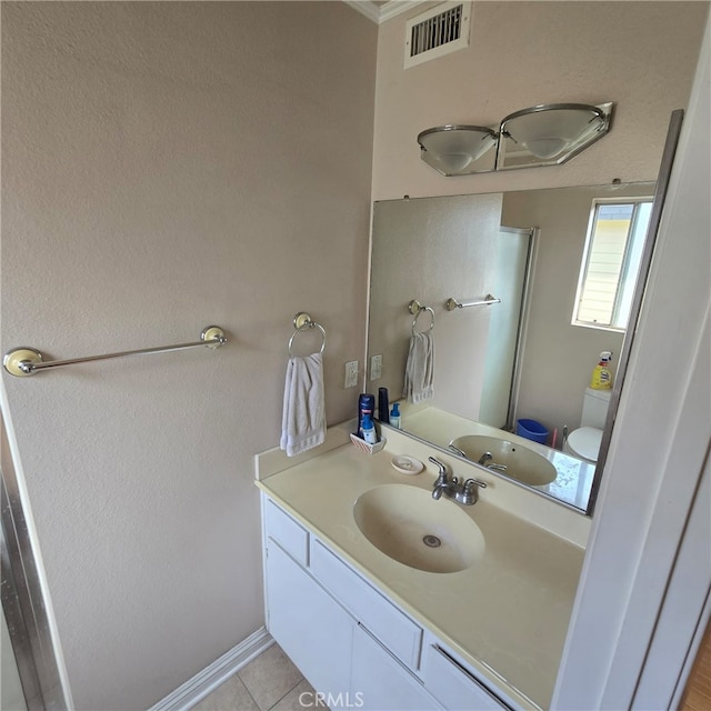 bathroom featuring an enclosed shower, tile patterned floors, visible vents, and vanity