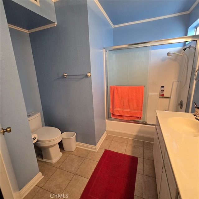 full bathroom with tile patterned flooring, vanity, toilet, baseboards, and ornamental molding