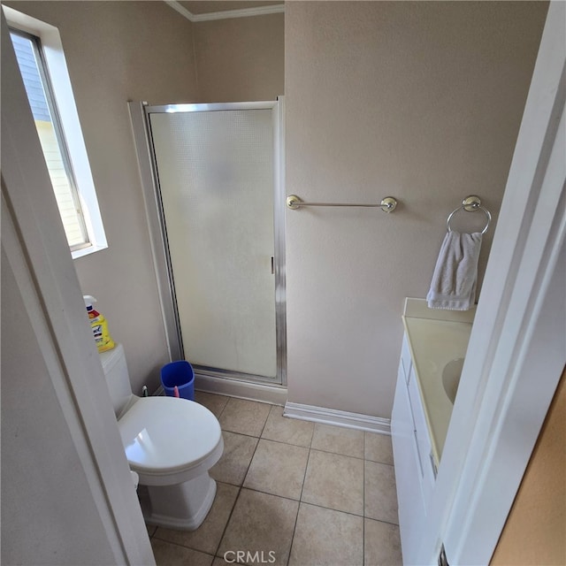 bathroom featuring tile patterned floors, baseboards, a stall shower, and toilet