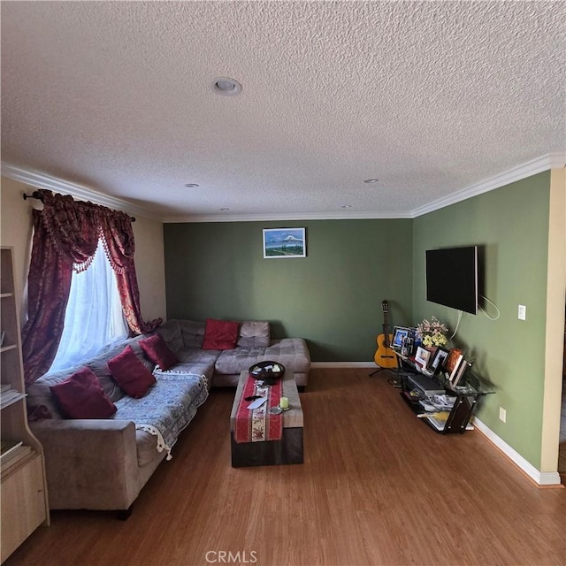 living area with crown molding, a textured ceiling, baseboards, and wood finished floors
