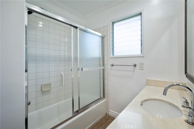 bathroom with vanity, ornamental molding, and enclosed tub / shower combo