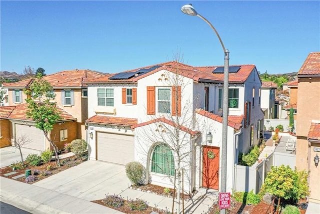 39580 Strada Pozzo, Lake Elsinore, CA 92532 - view of front facade with a tiled roof, concrete driveway, fence, stucco siding, and a residential view