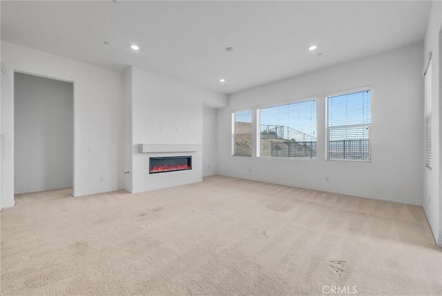 2575 Sierra Bella Dr, Corona, CA 92882 - unfurnished living room with light colored carpet, baseboards, a glass covered fireplace, and recessed lighting