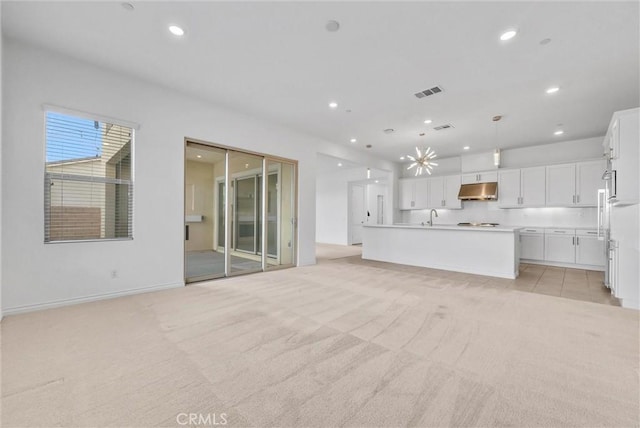 2575 Sierra Bella Dr, Corona, CA 92882 - unfurnished living room featuring baseboards, recessed lighting, visible vents, light colored carpet, and a sink