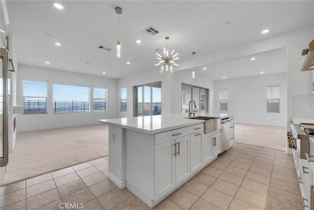 2575 Sierra Bella Dr, Corona, CA 92882 - kitchen with open floor plan, light colored carpet, a sink, and visible vents