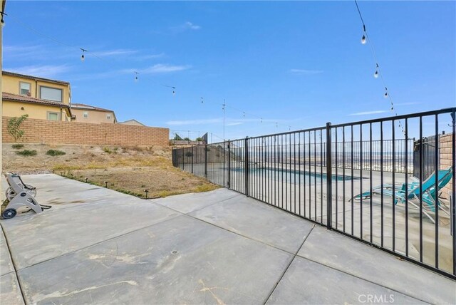 2575 Sierra Bella Dr, Corona, CA 92882 - view of patio / terrace with a fenced in pool and a fenced backyard
