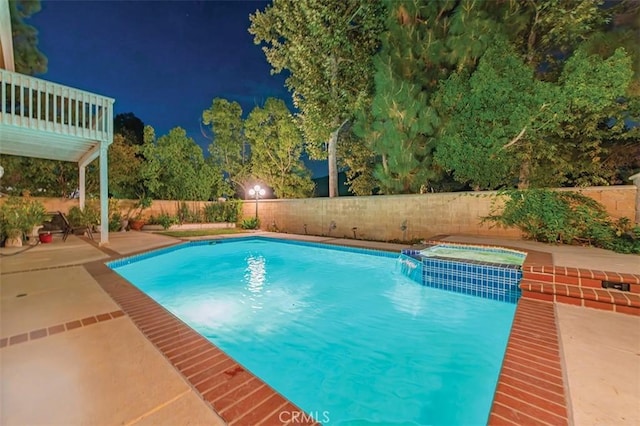 1731 Via Ln, Loma, Chino Hills, CA 91709 - pool at night featuring a fenced backyard, a patio, and a pool with connected hot tub