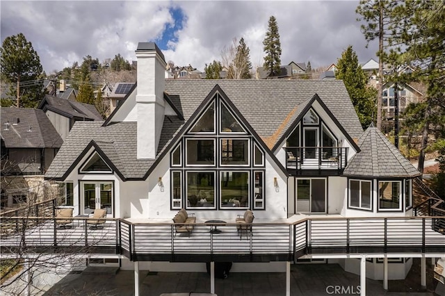 729 Brentwood Dr, Lake Arrowhead, CA 92352 - back of house with stucco siding, a chimney, roof with shingles, a balcony, and french doors