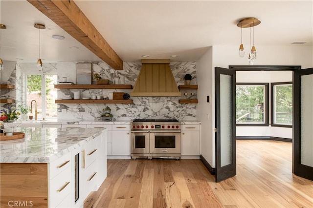 729 Brentwood Dr, Lake Arrowhead, CA 92352 - kitchen with white cabinets, premium range hood, range with two ovens, and open shelves
