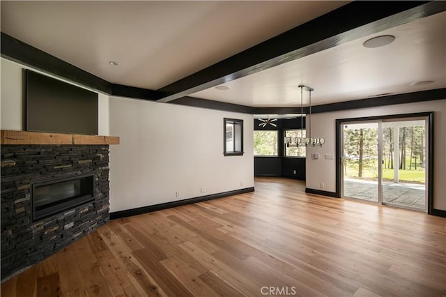 729 Brentwood Dr, Lake Arrowhead, CA 92352 - unfurnished living room featuring wood finished floors, beamed ceiling, a fireplace, and baseboards