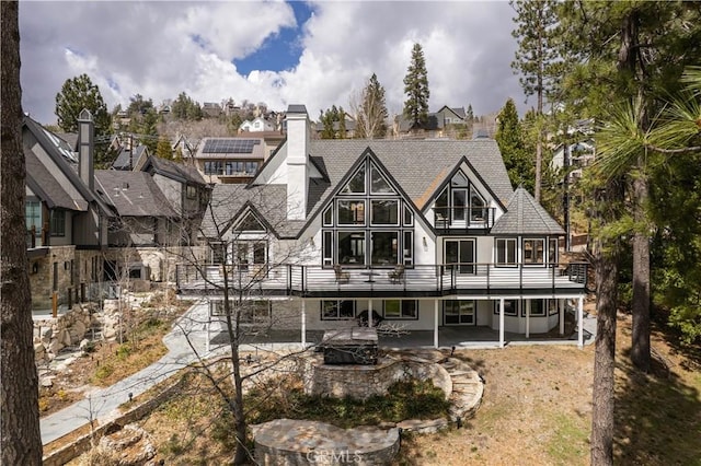 729 Brentwood Dr, Lake Arrowhead, CA 92352 - rear view of property with an outdoor fire pit, a shingled roof, a patio, and a chimney