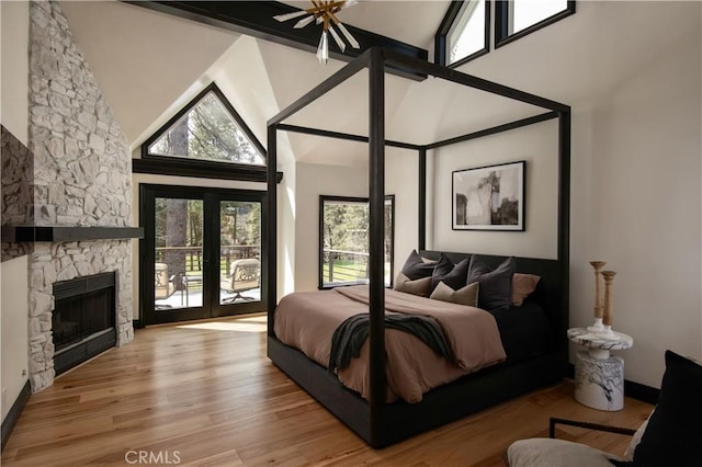 729 Brentwood Dr, Lake Arrowhead, CA 92352 - bedroom featuring high vaulted ceiling, a fireplace, access to exterior, and wood finished floors