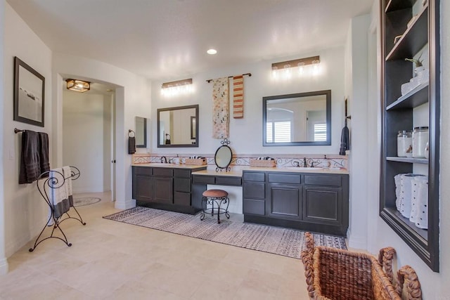 bathroom with a sink, recessed lighting, and double vanity