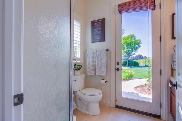 entryway featuring baseboards and light tile patterned floors