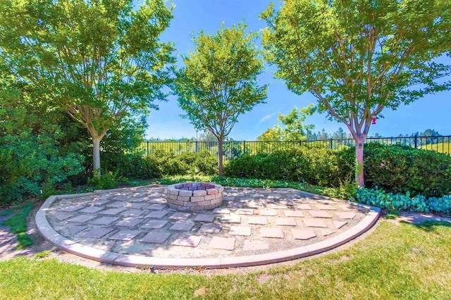 view of patio featuring fence and a fire pit