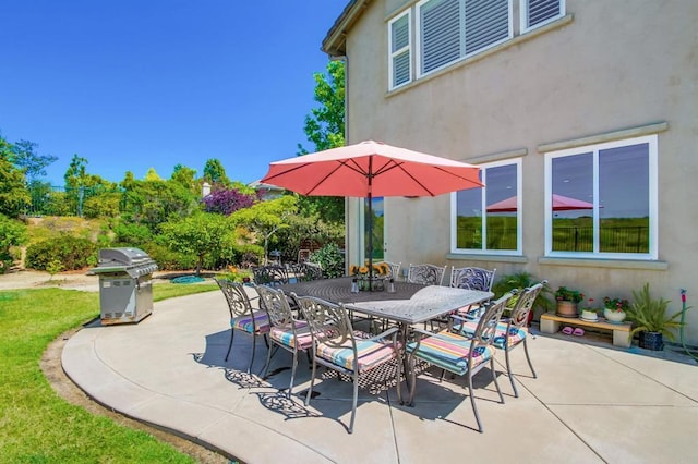 view of patio / terrace featuring outdoor dining area and a grill