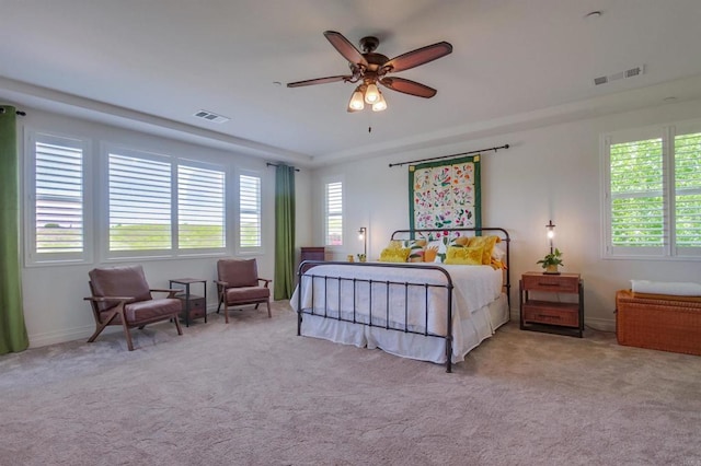 bedroom with visible vents and multiple windows