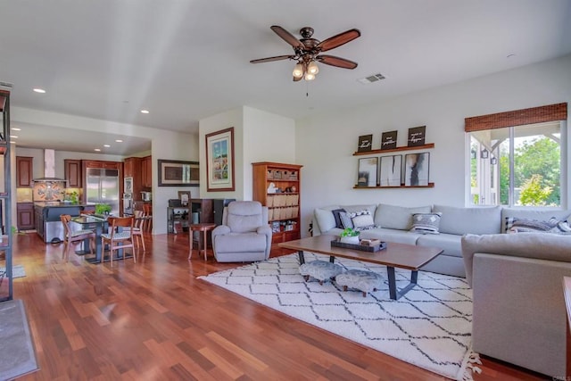 living room featuring recessed lighting, wood finished floors, visible vents, and ceiling fan