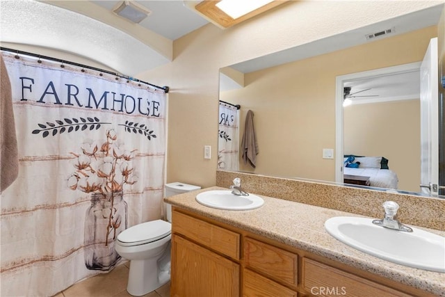 full bath featuring toilet, a sink, tile patterned flooring, and visible vents