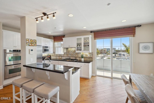 1551 Windshore Way, Oxnard, CA 93035 - kitchen featuring stainless steel appliances, a breakfast bar, white cabinets, and recessed lighting