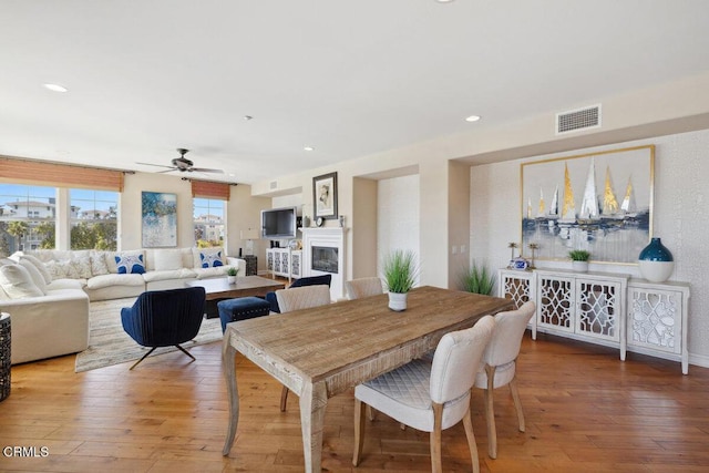 1551 Windshore Way, Oxnard, CA 93035 - dining area with ceiling fan, a glass covered fireplace, light wood-type flooring, and recessed lighting