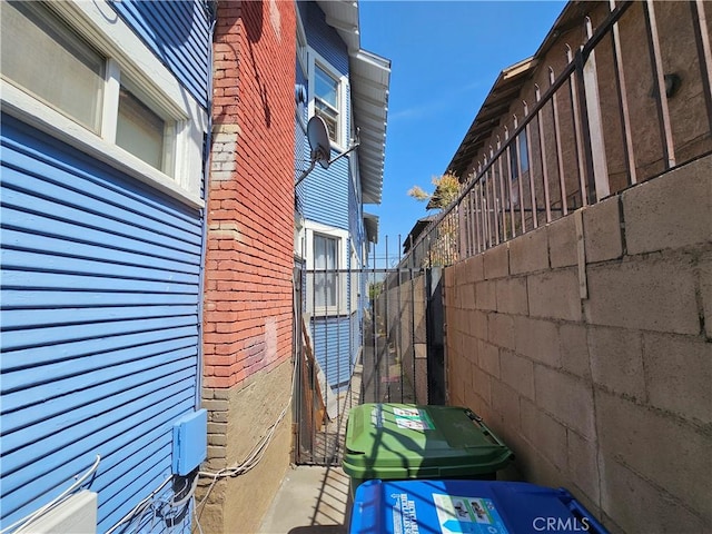 view of side of property featuring fence