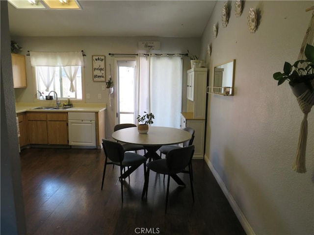 dining area with baseboards and dark wood-style floors