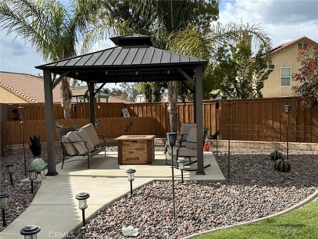 view of patio / terrace with an outdoor fire pit, fence, and a gazebo
