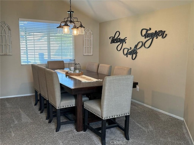 carpeted dining space featuring baseboards and vaulted ceiling