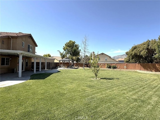 view of yard featuring a gazebo, a patio area, and a fenced backyard