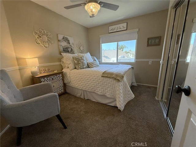 bedroom featuring ceiling fan, dark colored carpet, and baseboards