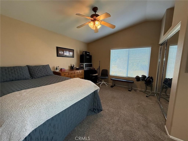 bedroom featuring baseboards, ceiling fan, carpet flooring, and vaulted ceiling