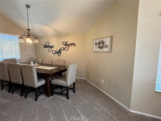 carpeted dining area featuring vaulted ceiling, a chandelier, and baseboards