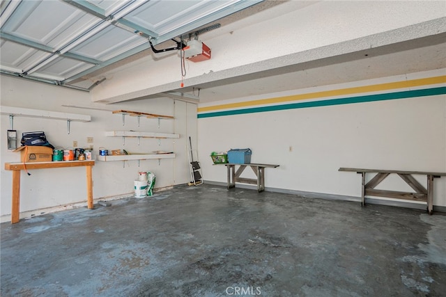 garage featuring a garage door opener and a workshop area